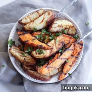 grilled potato wedges with tongs on a gray table