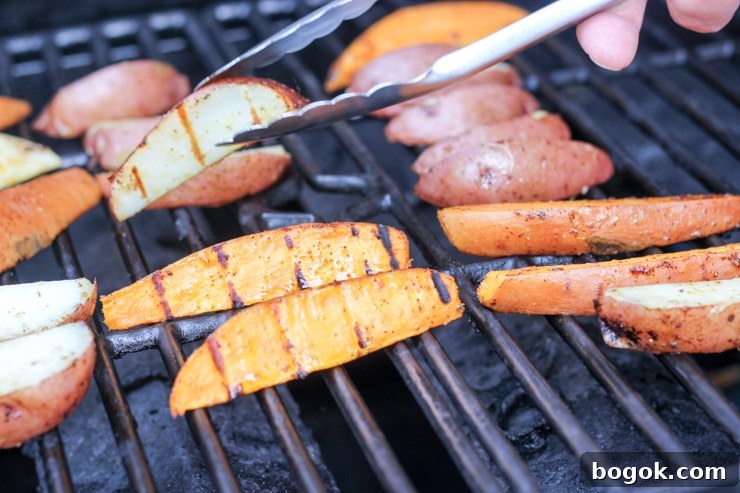 Crispy Grilled Potato Wedges with Garlic Herb Dip 9 Flipping potato over with tongs
