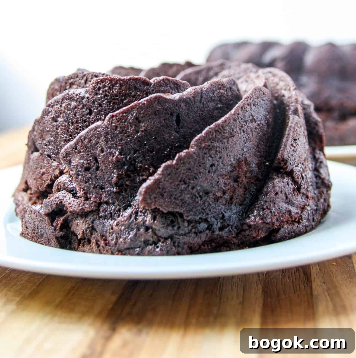 Moist Fluffy Air Fryer Cake Recipe 6 The baked cake cooling on a plate after being removed from the pan.