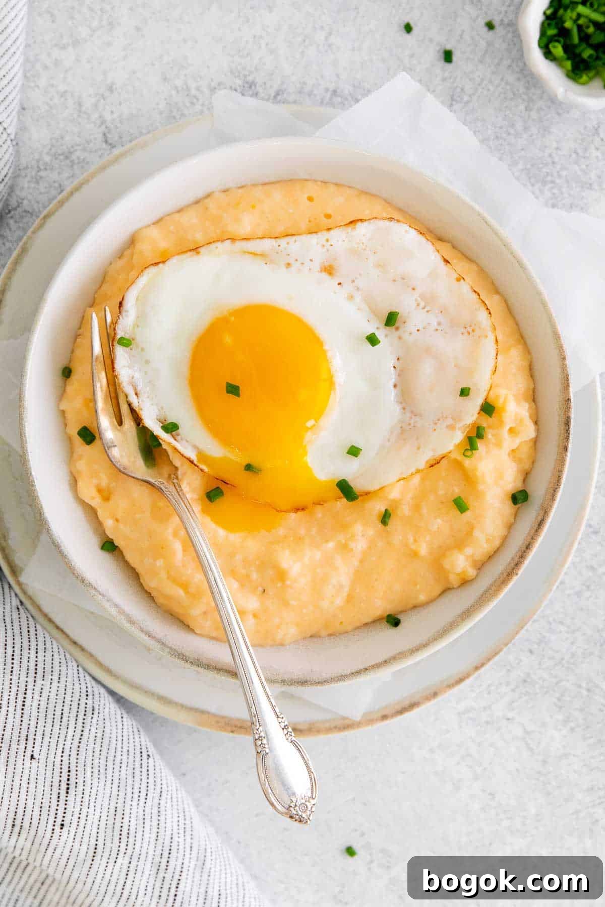 Classic Southern Grits and Eggs Breakfast Recipe 3 Grits and eggs in a bowl with a spoon
