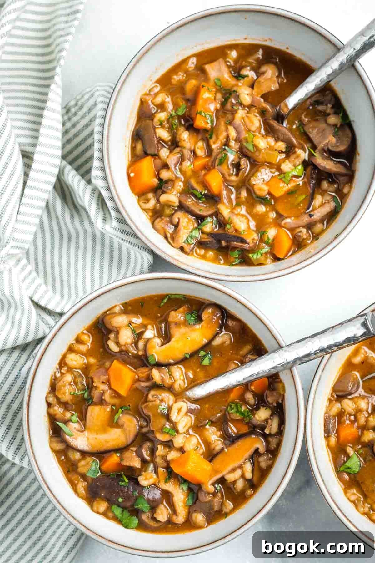 Hearty Vegan Miso Mushroom and Barley Soup Recipe 2 Bowls of chunky mushroom barley soup.