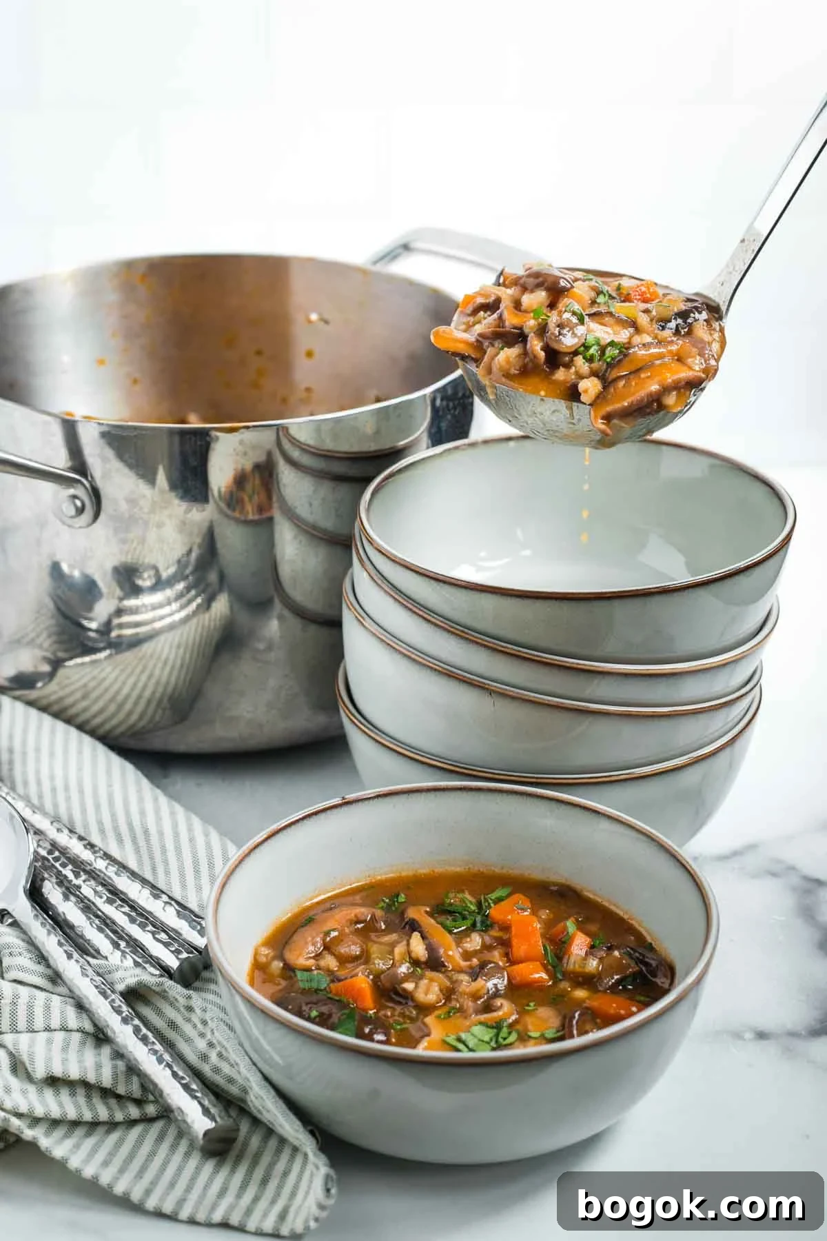 Hearty Vegan Miso Mushroom and Barley Soup Recipe 16 Ladling mushroom barley soup into bowls from a soup pot.