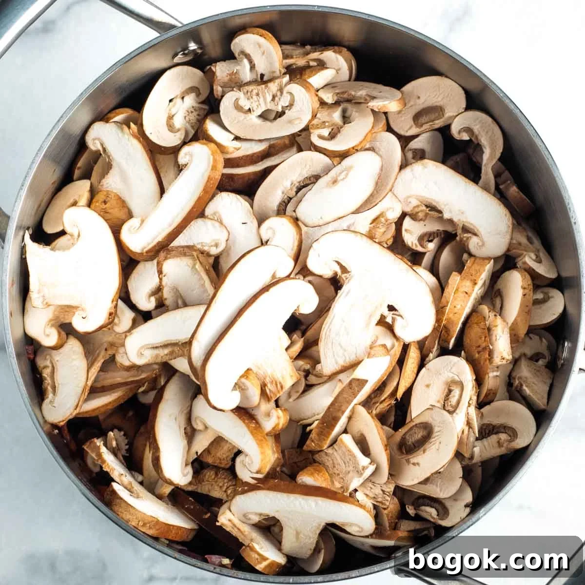 Hearty Vegan Miso Mushroom and Barley Soup Recipe 10 Sliced shitake and portobello mushrooms in a soup pot.