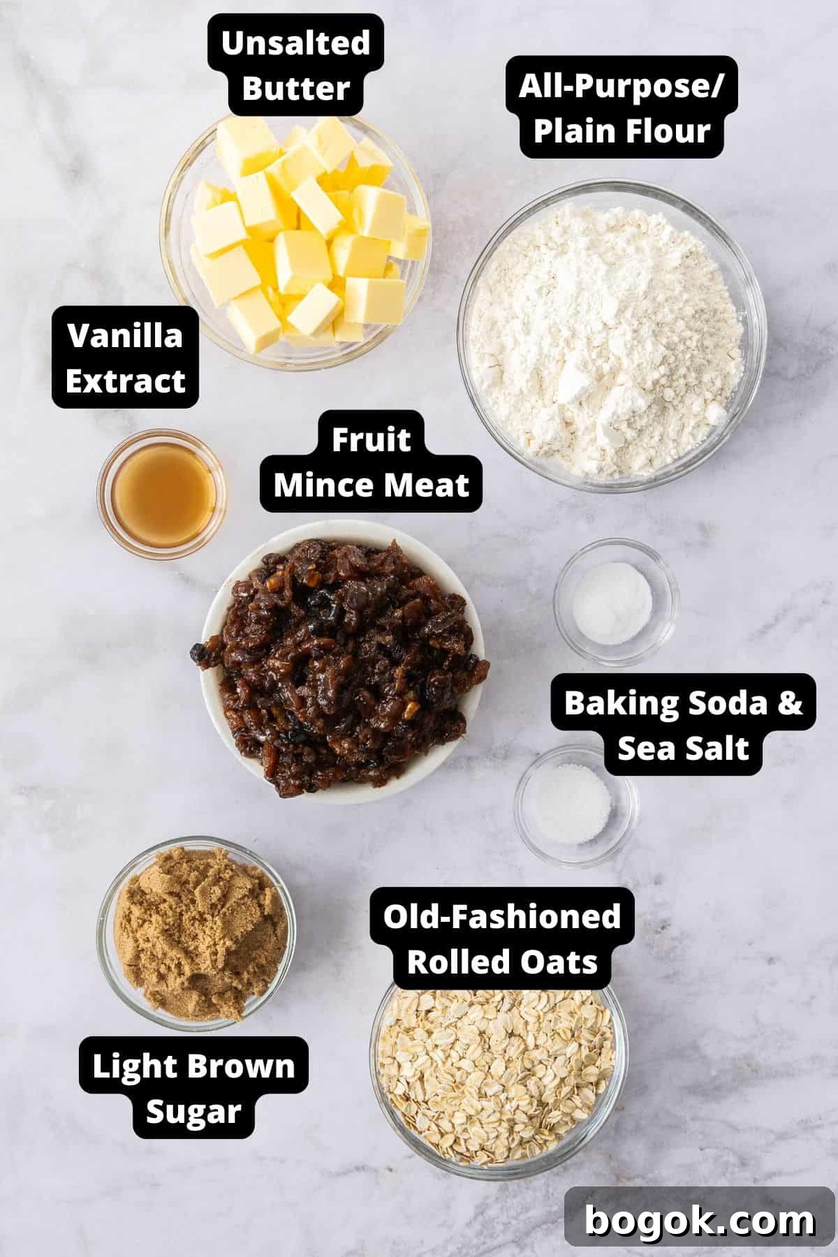 Fruit Mince Oatmeal Bars Recipe — Chewy Fruit & Oat Squares 3 Ingredients in this recipe on a white marble background.