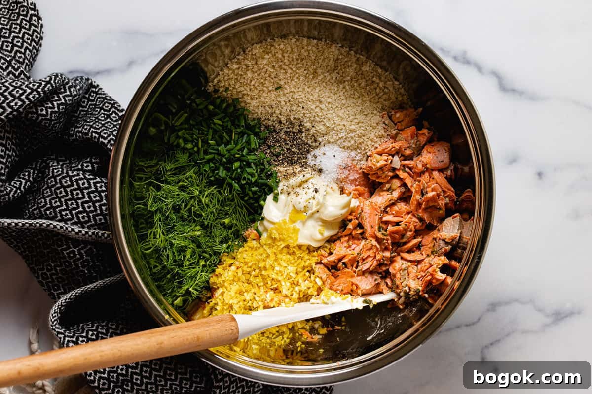 Metal bowl filled with ingredients to make salmon cakes