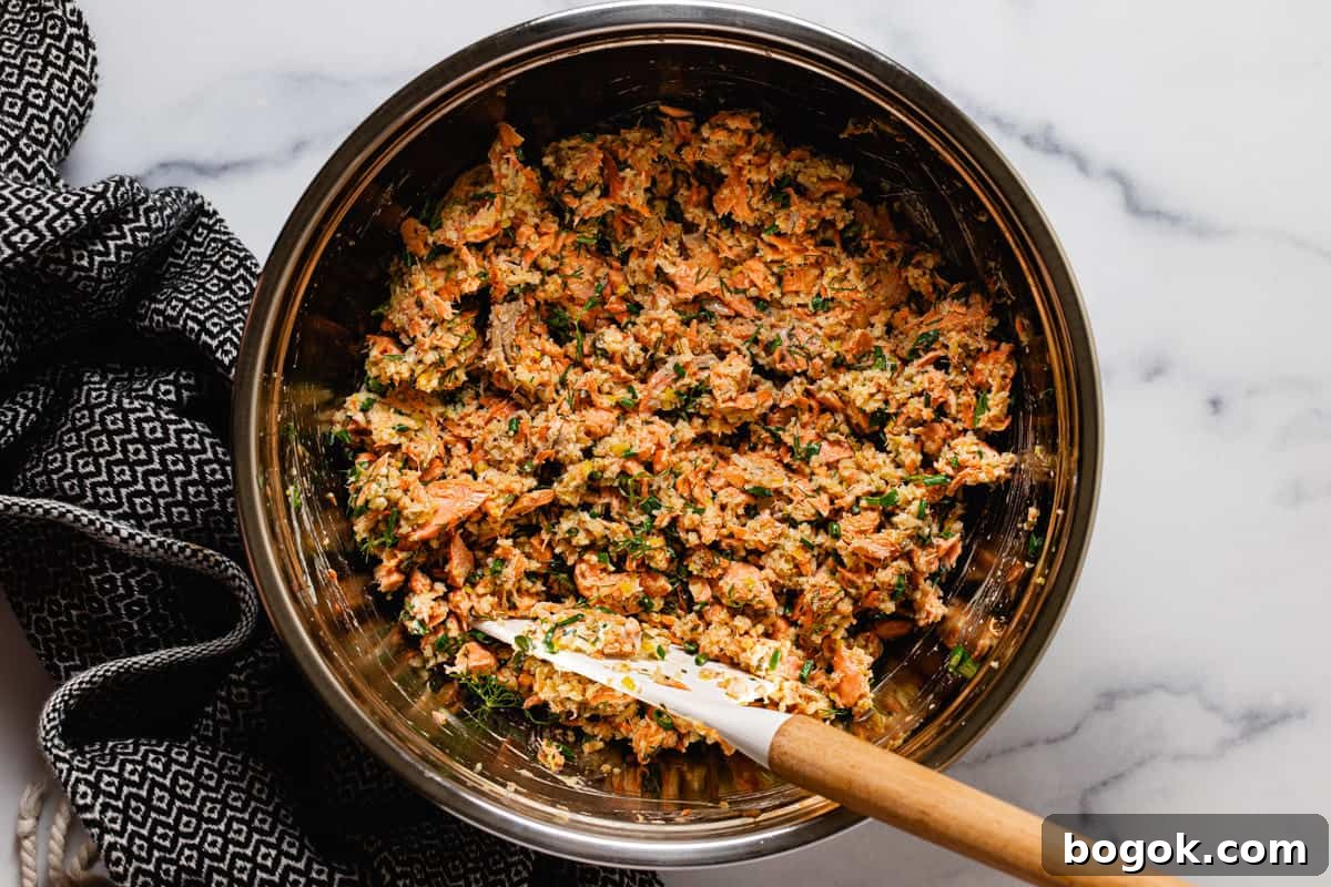 Metal bowl filled with ingredients to make salmon cakes