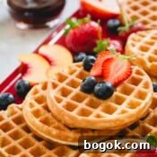 a stack of waffles with berries