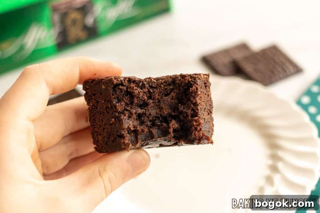 After Eight Mint Brownies Recipe — Classic Chocolate Mint Treat 3 hand holding one of the after eight brownies with a bite missing