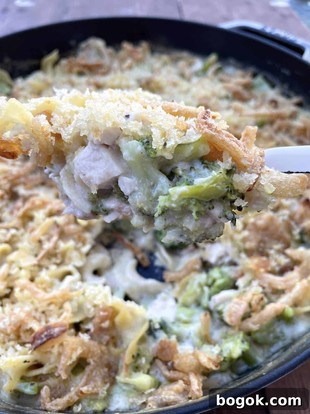Baked Cheesy Chicken and Broccoli Noodle Casserole 2 A scoop of cheesy chicken noodle casserole being served.