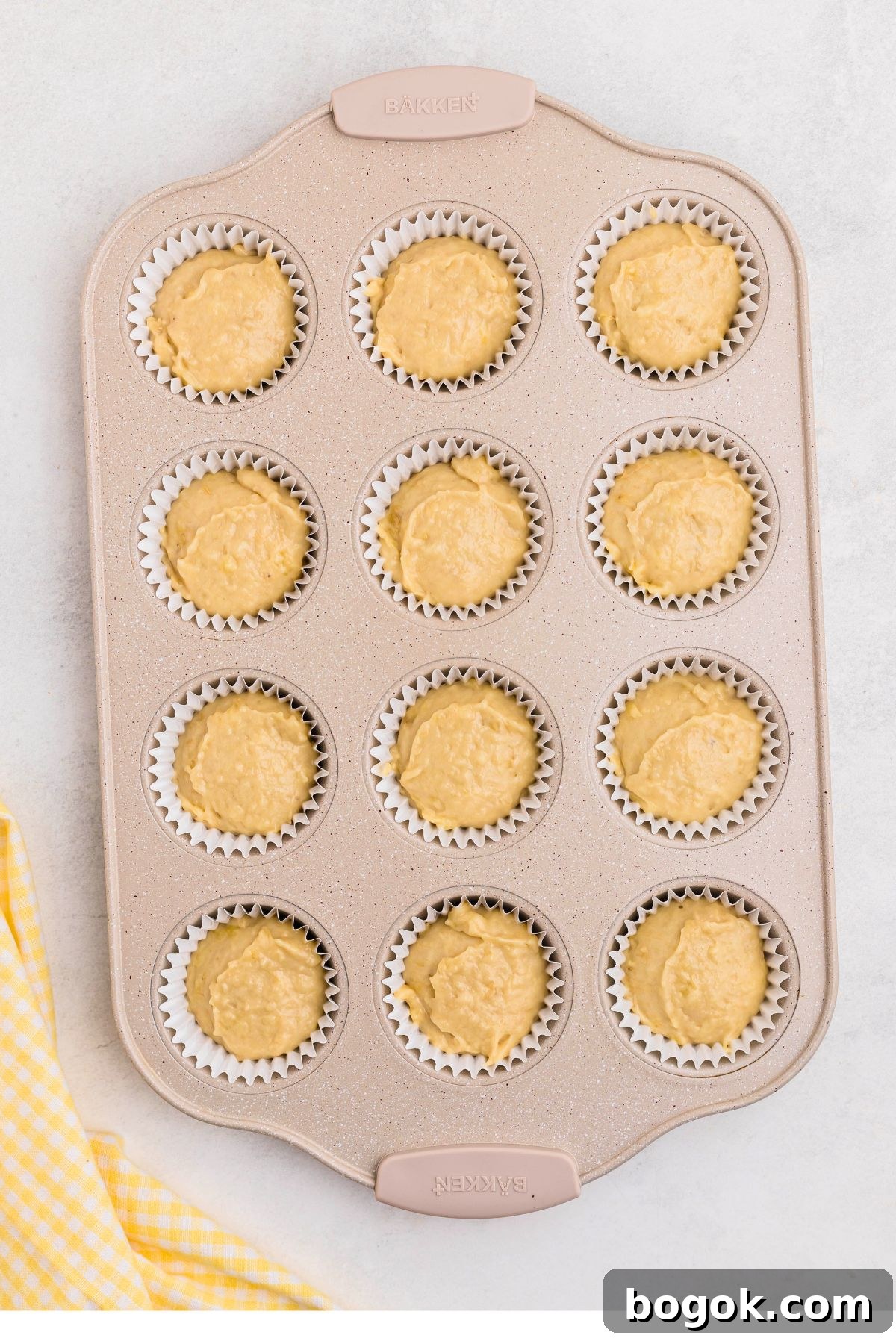 Banana Bread Muffins with Cinnamon Streusel 7 Muffin pan filled with banana bread muffin dough before baking.