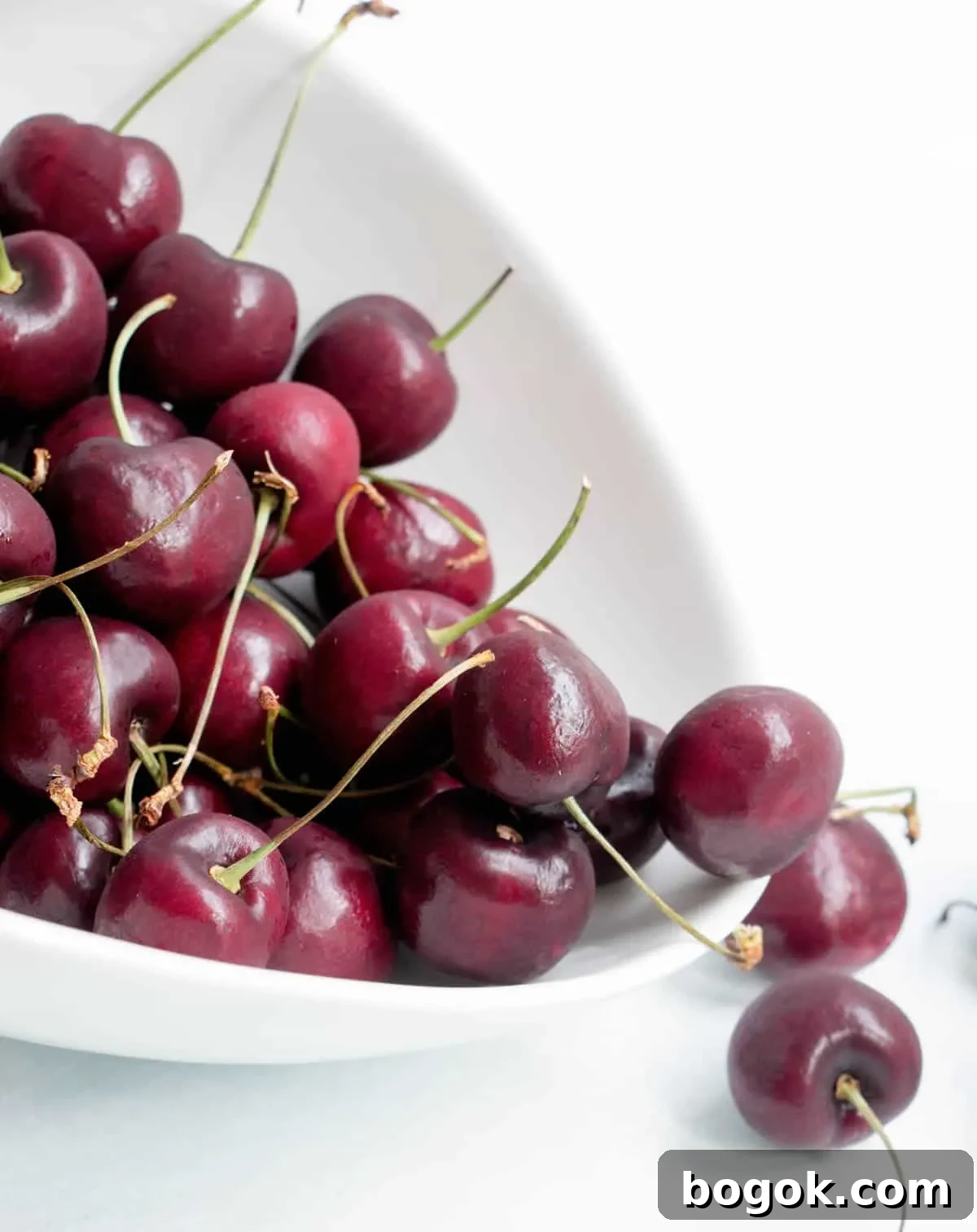 How to Make Fresh Sweet Cherry Sauce 3 Cherries spilling out of a bowl