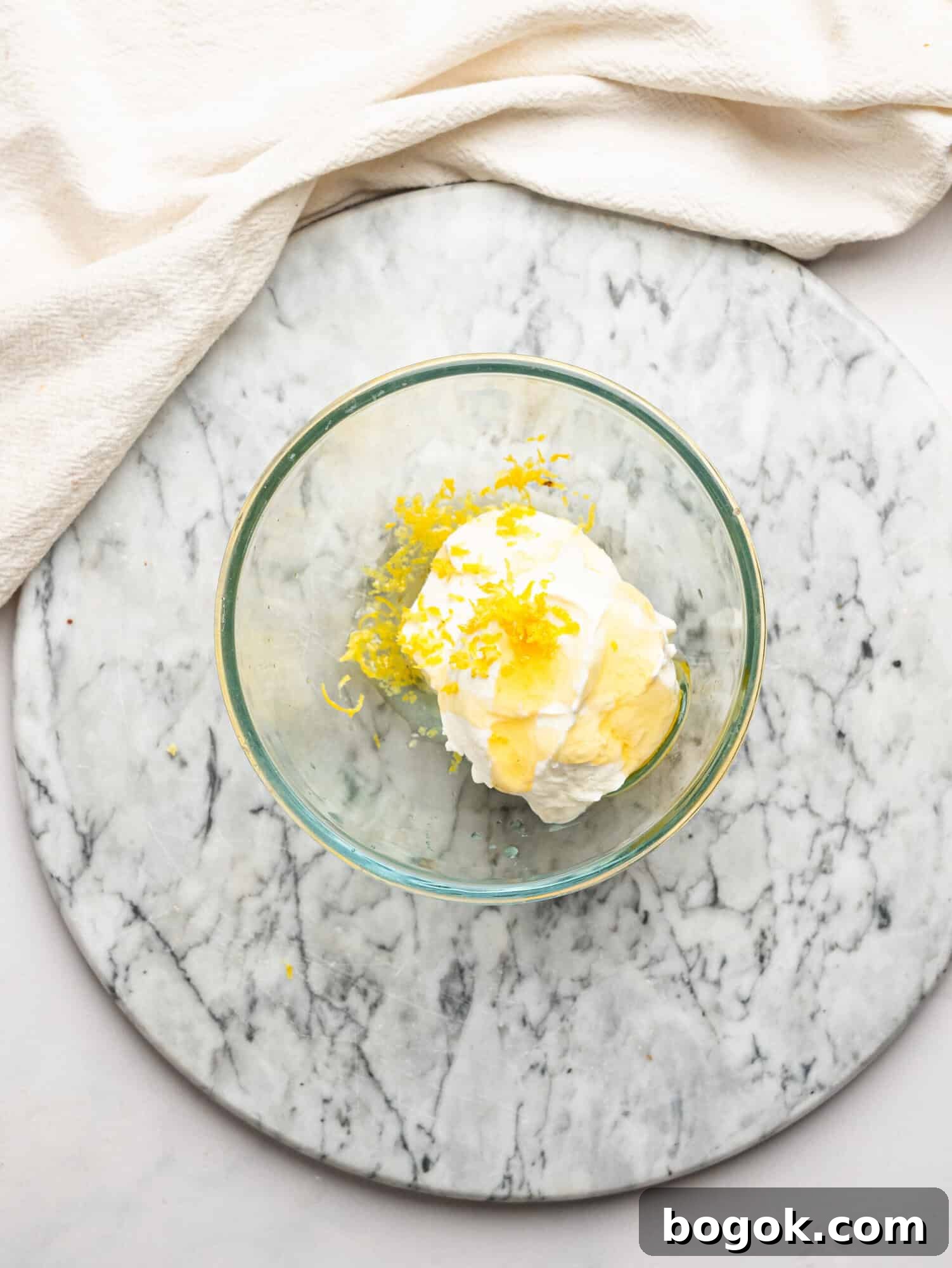 Lemon Cheesecake Overnight Weet-Bix Recipe 9 Cottage cheese, Greek yogurt, honey, lemon juice, and lemon zest added to a glass bowl to make the lemon cheesecake filling.