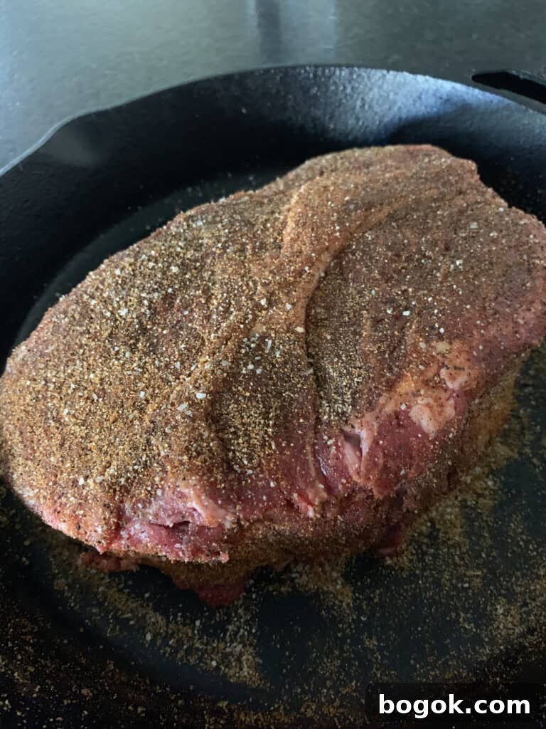 seasoned chuck roast in a cast iron skillet