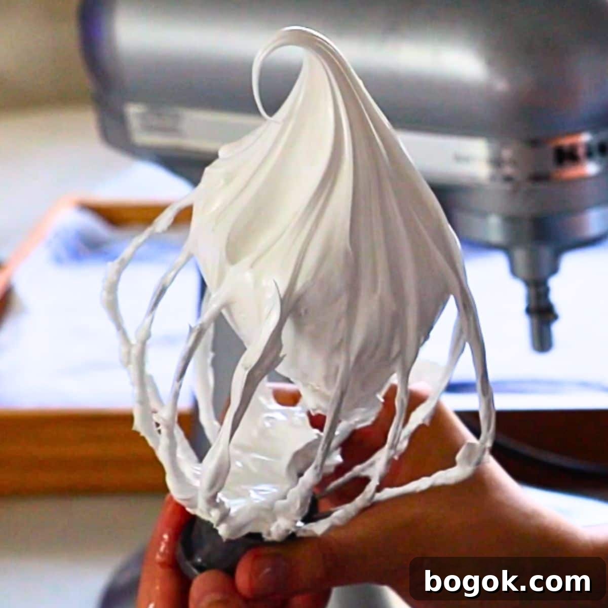 Swiss Meringue Buttercream: Glossy, Stable Frosting Recipe 2 the perfect Swiss meringue on a whisk for Swiss buttercream