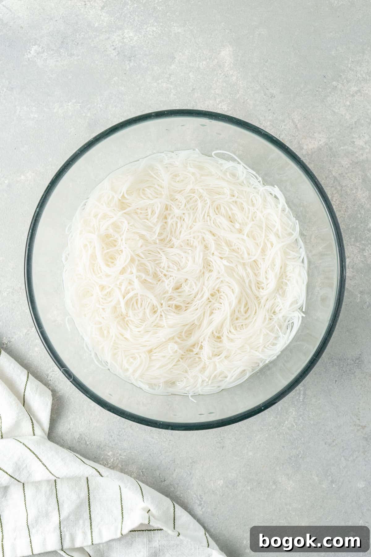 San Choy Bow Lettuce Wrap Bowls - Chinese Pork Recipe 4 The rice noodles in a bowl of water.