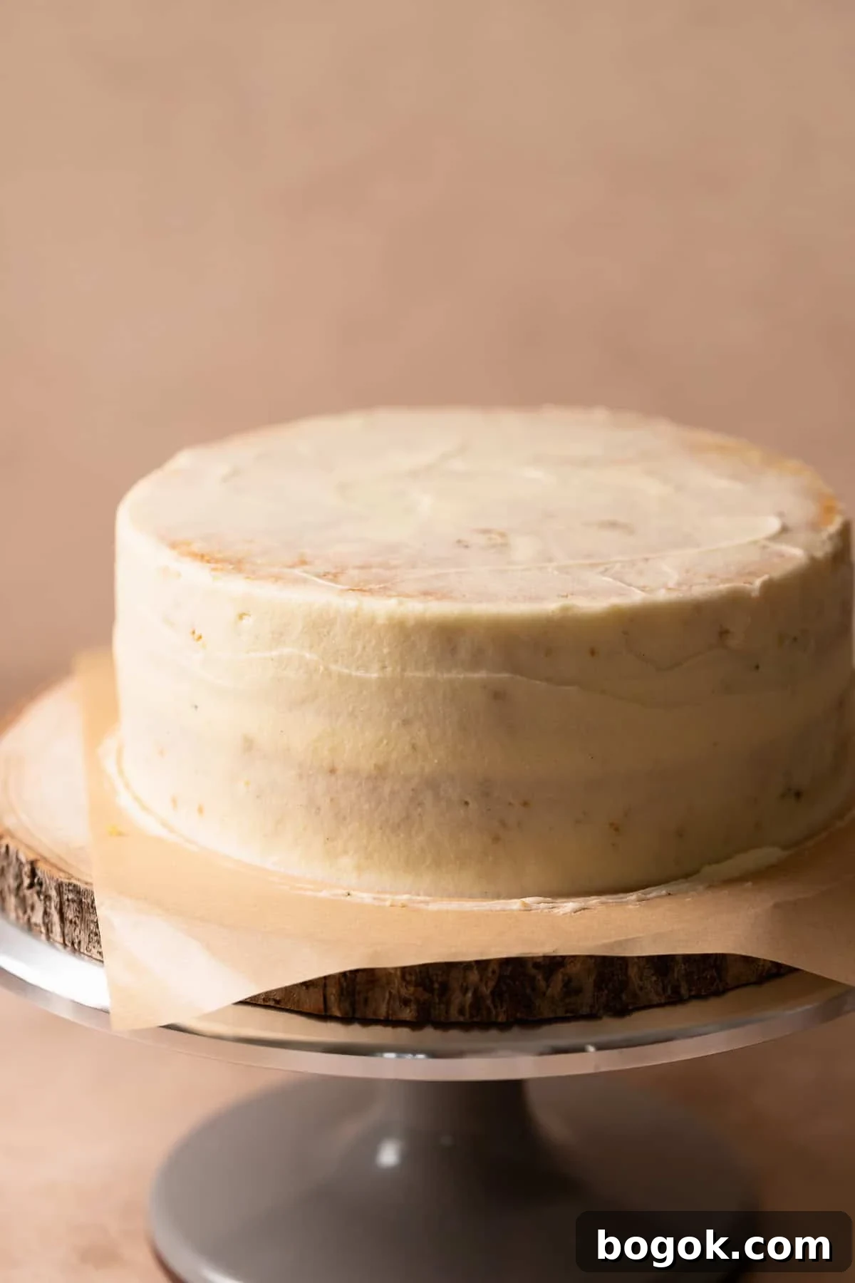 Lemon cake with a thin layer of cream cheese frosting covering it.