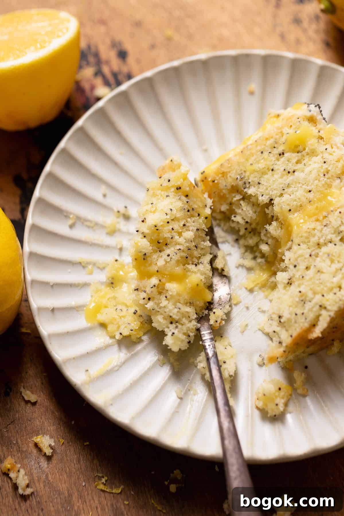 A bite of lemon poppy cake on a fork.