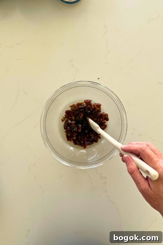 Soaking dates in water in a bowl to make sourdough date and walnut loaf cake.