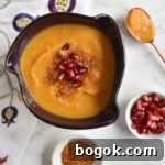 Last-Minute Rosh Hashanah Prep Guide 17 soup in purple bowl with copper spoon and dukkah and arils