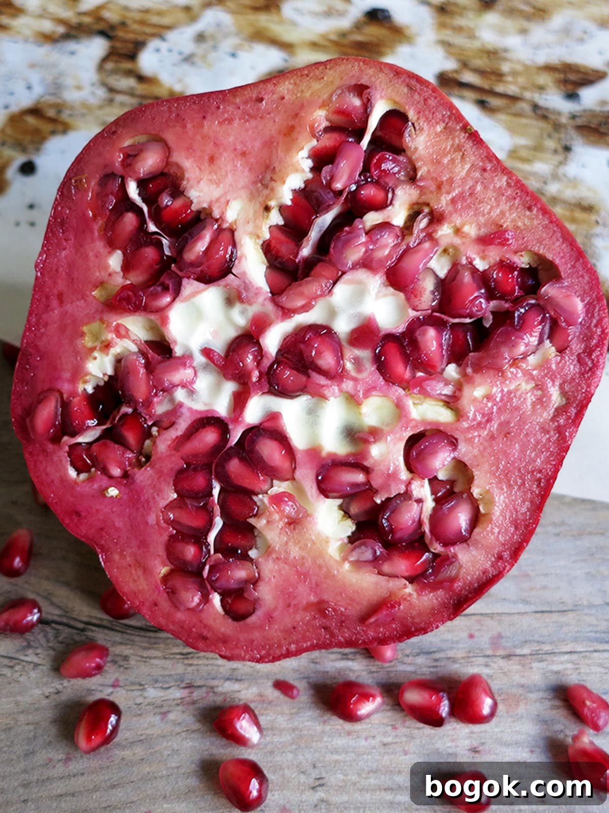 Last-Minute Rosh Hashanah Prep Guide 27 Straight on view of a pomegranate that's been cut open to reveal the seeds inside.