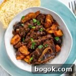 Last-Minute Rosh Hashanah Prep Guide 7 Braised beef brisket in a bowl with a slice of challah on the side.