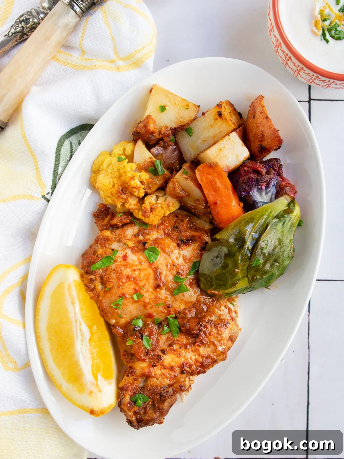 Last-Minute Rosh Hashanah Prep Guide 8 As part of Rosh hashanah food ideas post, a white plate showing harissa chicken and vegetables to introduce the chicken section of the post.