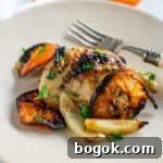 Last-Minute Rosh Hashanah Prep Guide 9 Chicken thigh with roasted clementines and fennel on a tan plate.