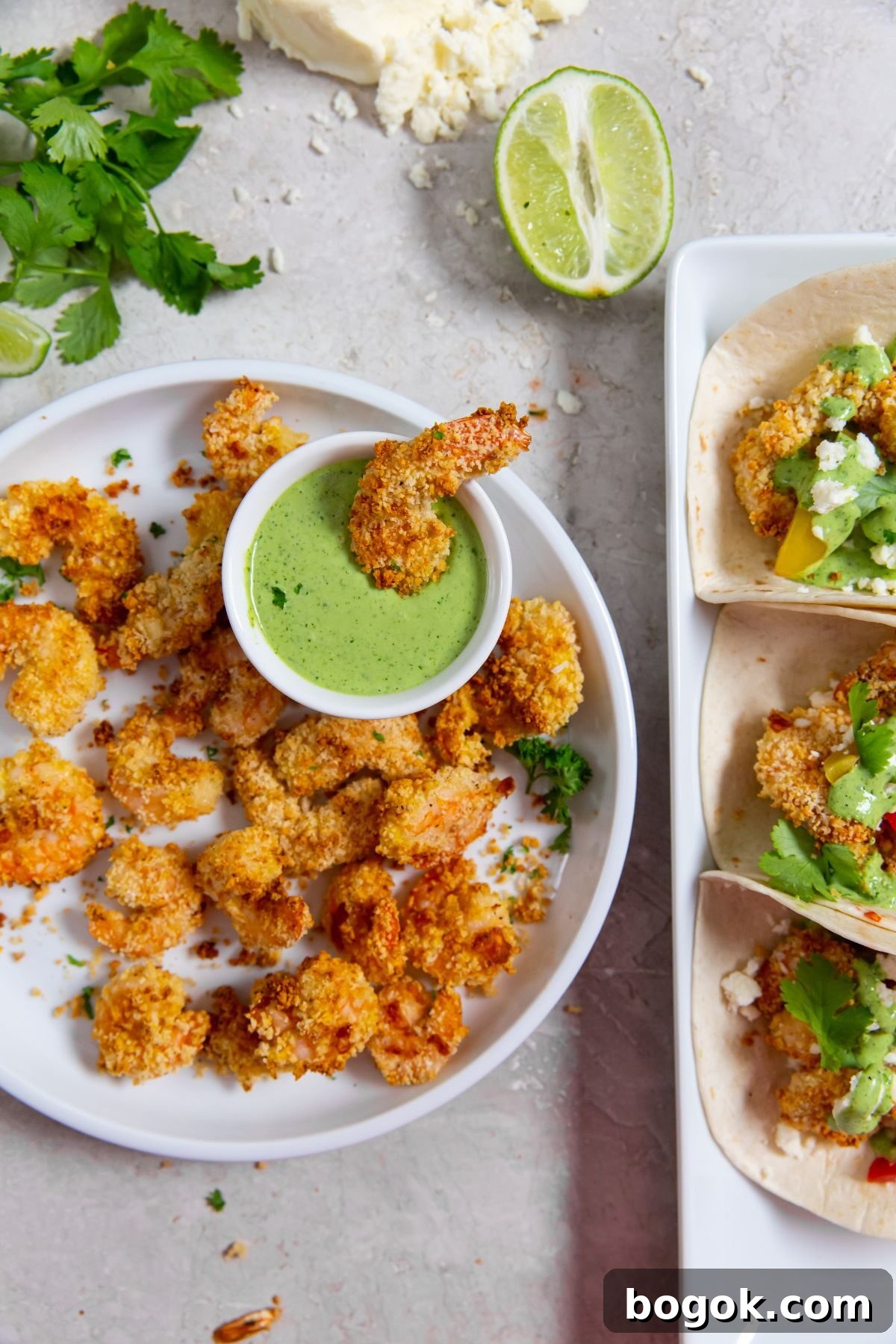 Crispy Panko Shrimp in the Air Fryer 2 air fried panko shrimp on white plate with dipping sauce next to a plate of three shrimp tacos