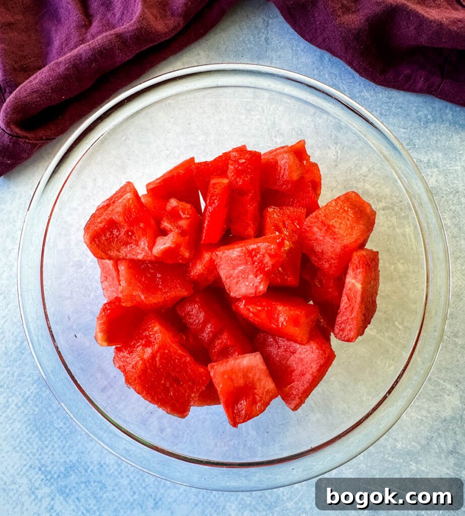 Frozen Watermelon Margarita Recipe for Summer 3 fresh watermelon chunks in a glass bowl