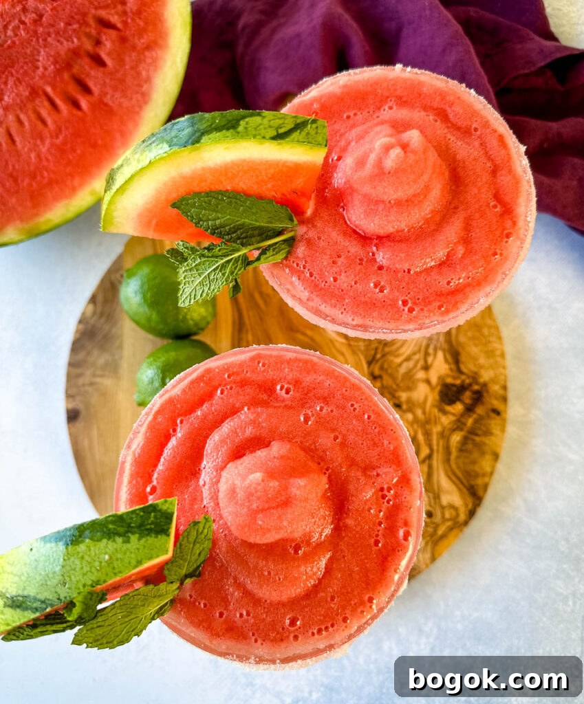 Frozen Watermelon Margarita Recipe for Summer 8 frozen margaritas in a sugar rimmed lined glass with fresh watermelon and limes