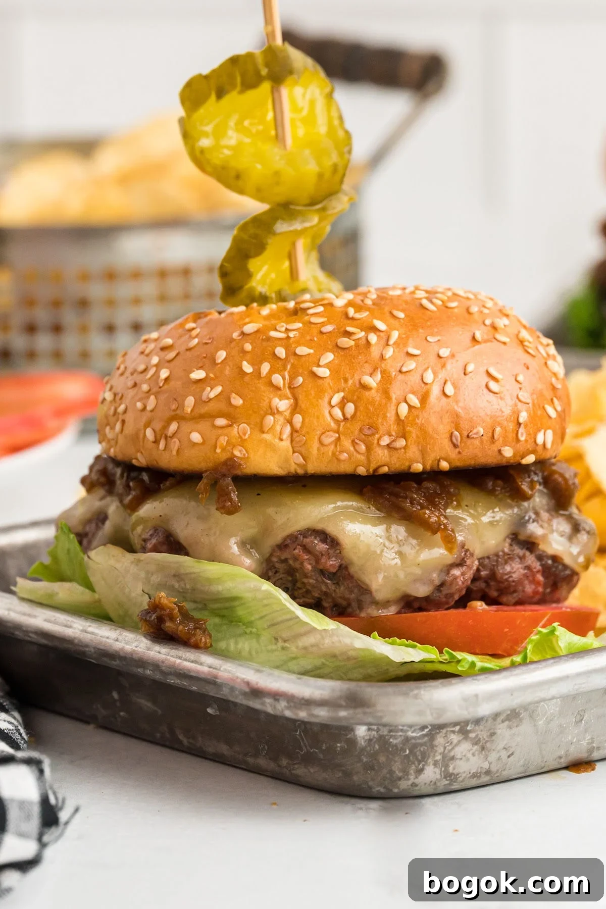 Juicy Cast Iron Skillet Burgers That Beat the Grill 2 close up view of burger with melted cheese