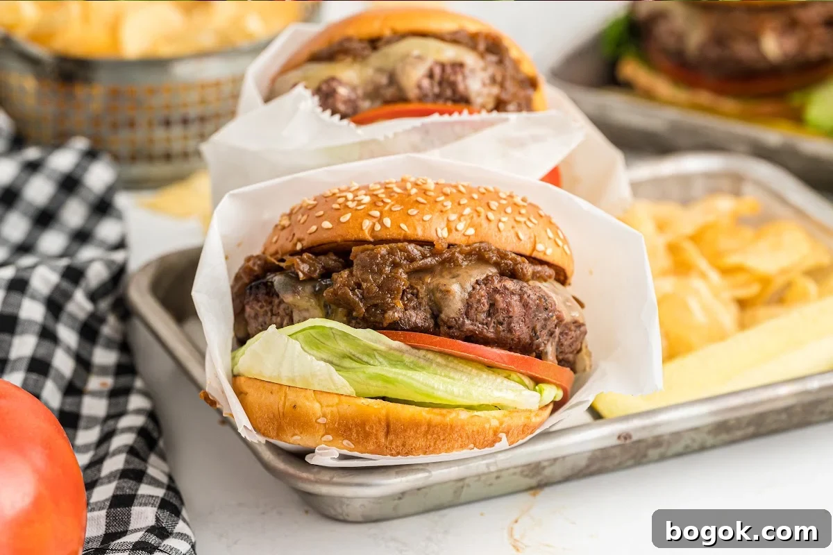 Juicy Cast Iron Skillet Burgers That Beat the Grill 8 finished burger wrapped in paper.
