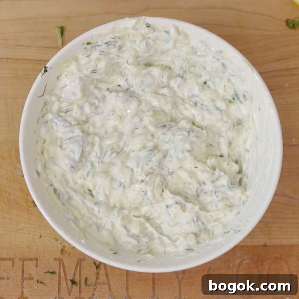 Authentic Greek Tzatziki Sauce Recipe 6 Step 3 - mix yogurt into drained grated cucumbers in a bowl