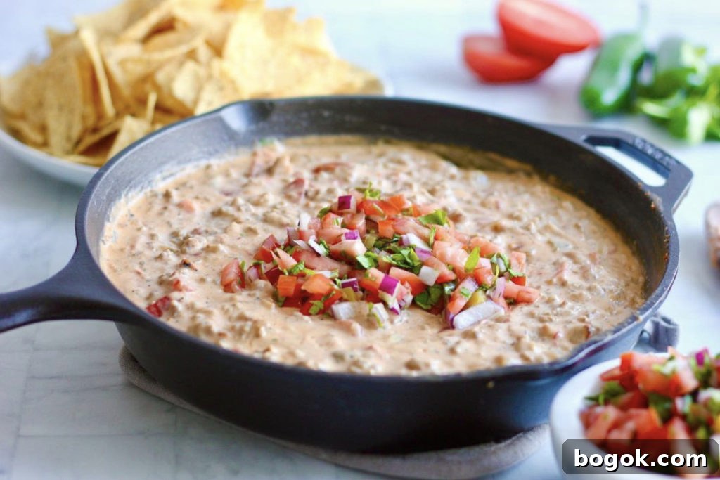 Creamy Sausage Queso Dip Recipe 2 skillet of SAUSAGE queso garnished with pico