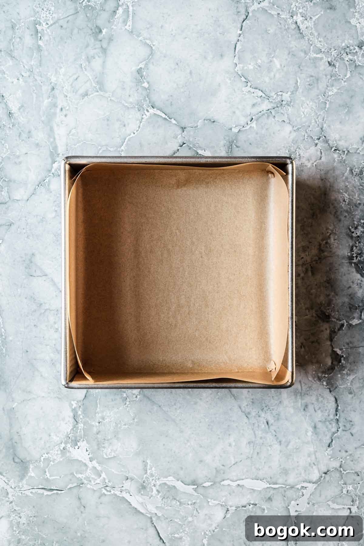 Classic Pink Coconut Ice Candy Recipe 8 A square baking pan lined with parchment paper.