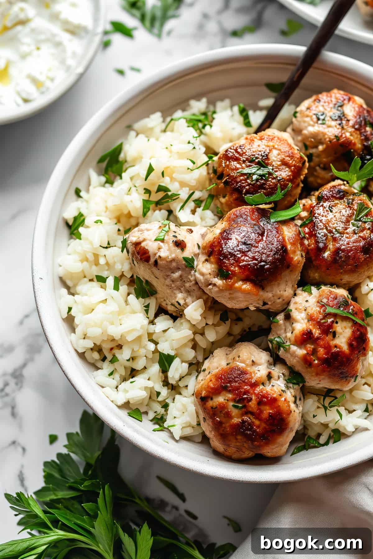 Greek-Style Chicken Meatballs with Lemon & Oregano 2 Greek chicken meatballs with feta and rice.